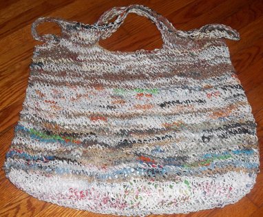 large, multi-colored beach bag, knit out of recycled plastic bags